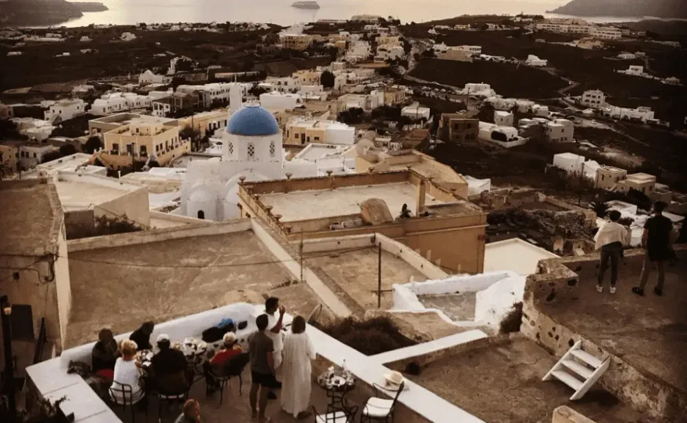 People eating on a scenic outlook in Santorini